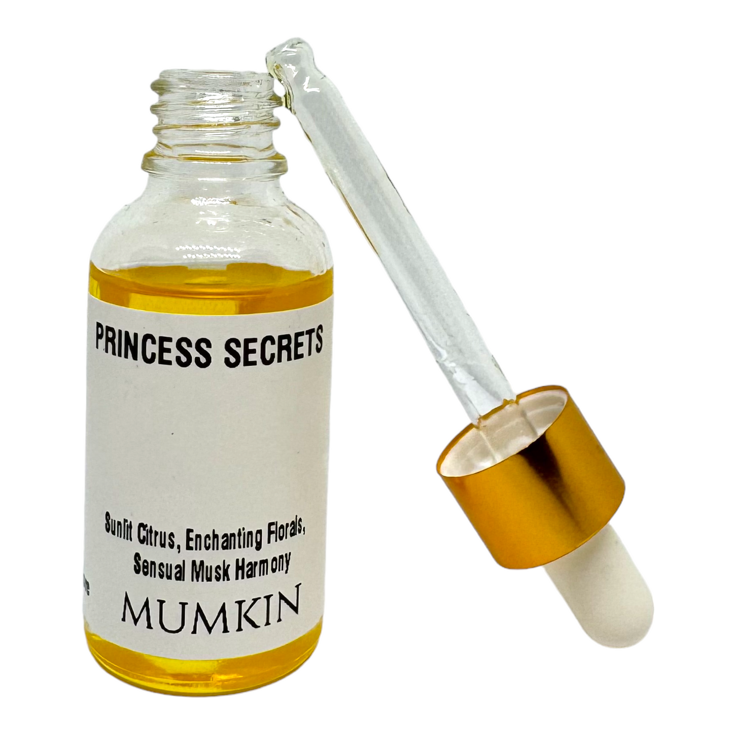 Close-up of a Princess Secrets fragrance oil bottle with a golden dropper and rich amber-colored liquid, featuring notes of sunlit citrus, enchanting florals, and sensual musk harmony by MUMKIN.