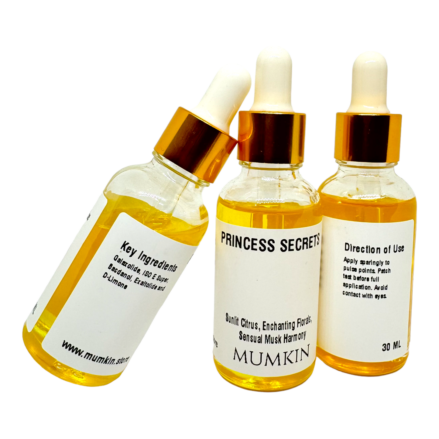 three glass bottles of "Princess Secrets" fragrance oil by MUMKIN. Each bottle features a golden dropper cap and contains a rich, golden-hued liquid. The labels on the bottles highlight key ingredients such as "Galaxolide 150E Super, Benzoin, and Ethylole And." The center bottle prominently displays the fragrance notes: "Sunlit Citrus, Enchanting Florals, Sensual Musk Harmony.