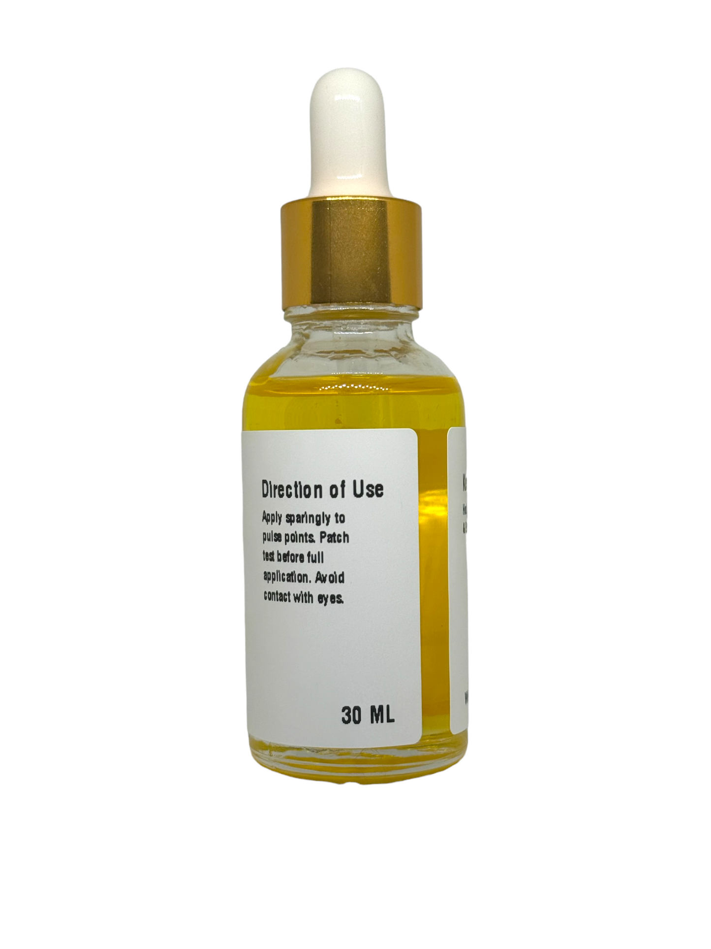 a close-up of a bottle labeled "Direction of Use," with instructions to "Apply sparingly to pulse points. Patch test before full application. Avoid contact with eyes." The bottle appears elegant, with a gold-colored cap and a dropper. The background is plain white, making the product stand out clearly.