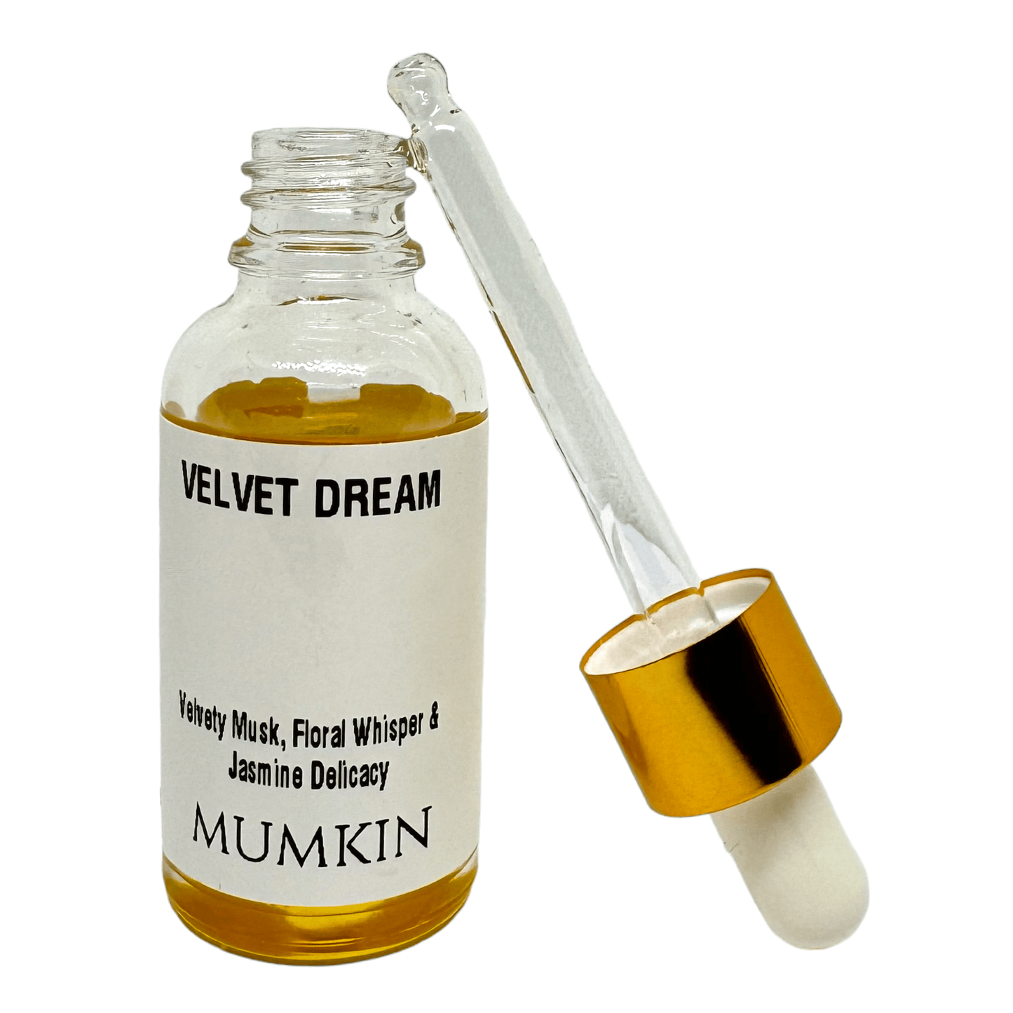 A 30ml glass dropper bottle labeled 'Velvet Dream Fragrance Oil' by Mumkin, featuring a gold cap and white label with black text. The fragrance notes include Velvety Musk, Floral Whisper, and Jasmine Delicacy. The liquid inside the bottle is golden yellow.