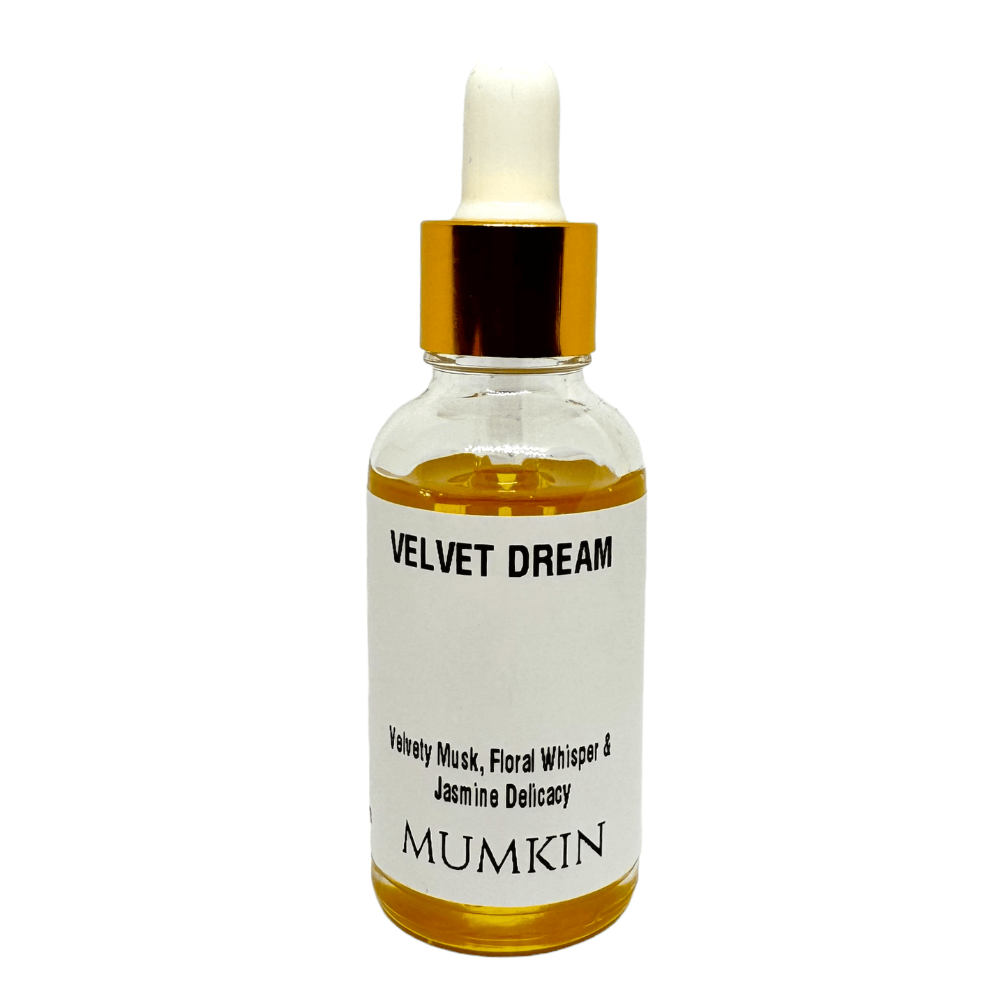 A 30ml glass dropper bottle labeled 'Velvet Dream Fragrance Oil' by Mumkin, featuring a gold cap and white label with black text. The fragrance notes include Velvety Musk, Floral Whisper, and Jasmine Delicacy. The liquid inside the bottle is golden yellow.