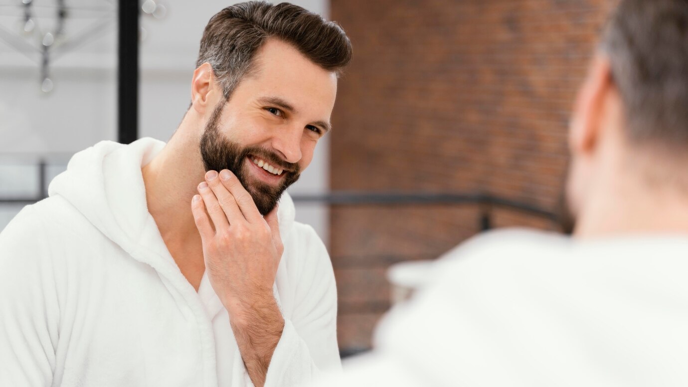 Man's self Grooming his Beard with smile