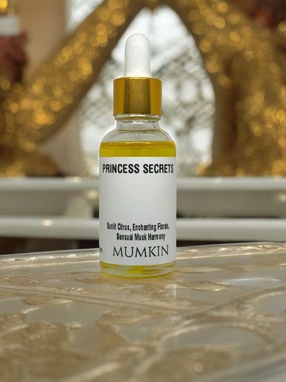 the "PRINCESS SECRETS" fragrance oil by MUMKIN. The bottle has a golden dropper cap and contains a rich, golden-hued liquid. The label highlights its scent profile: "Sunlit Citrus, Enchanting Florals, Sensual Musk Harmony." The background appears to have a decorative golden texture, giving the image an elegant and luxurious feel.