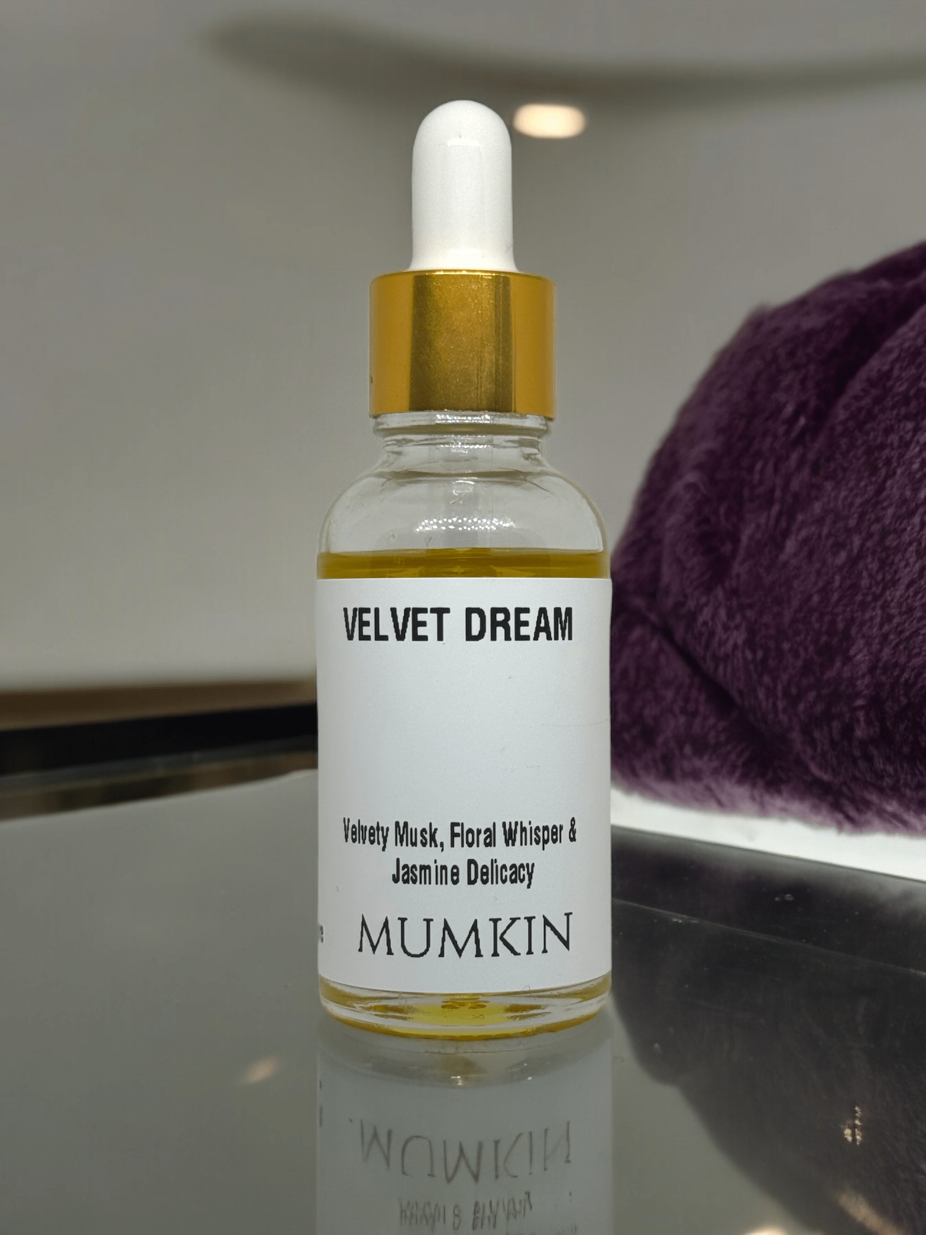 A 30ml glass dropper bottle labeled 'Velvet Dream' by Mumkin, featuring a gold cap and white label with black text. The fragrance notes include Velvety Musk, Floral Whisper, and Jasmine Delicacy. The liquid inside the bottle is golden yellow.
